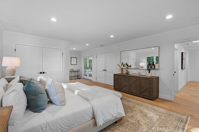 bedroom with ornamental molding and light hardwood / wood-style floors