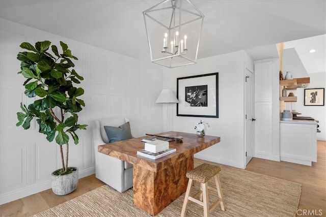 home office with an inviting chandelier and light wood-type flooring