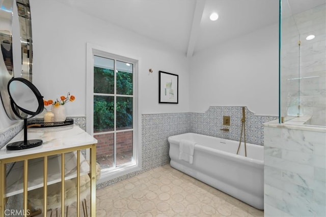 bathroom with tile walls, a wealth of natural light, and a washtub