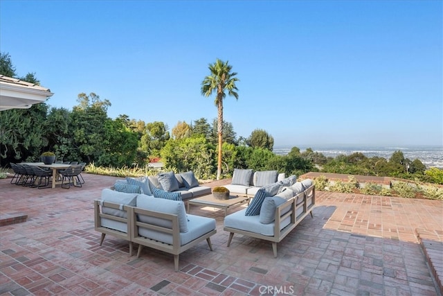 view of patio with an outdoor living space and a water view