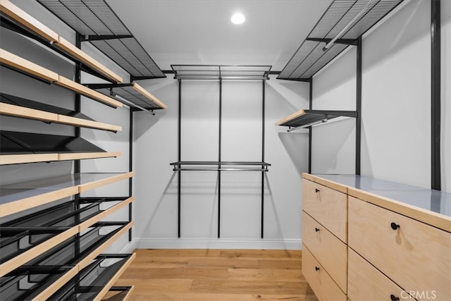 walk in closet featuring light hardwood / wood-style flooring