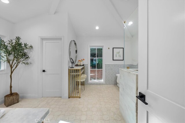 bathroom featuring lofted ceiling with beams