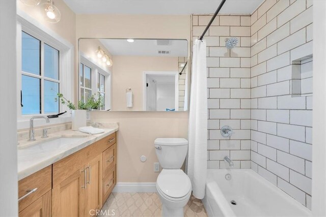 full bathroom with vanity, shower / bath combo with shower curtain, and toilet