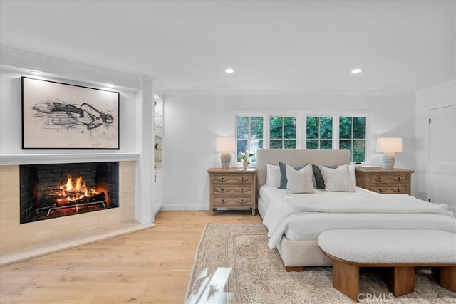 bedroom with ornamental molding and hardwood / wood-style flooring