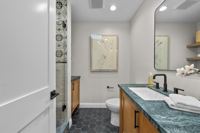 bathroom featuring toilet, walk in shower, vanity, and tile patterned floors