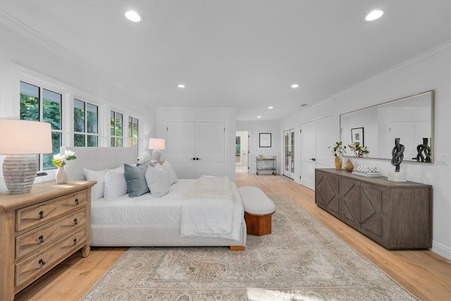 bedroom featuring light hardwood / wood-style floors and crown molding