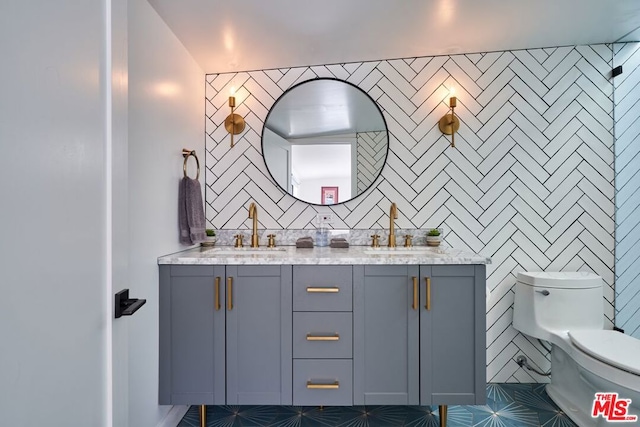 bathroom featuring vanity, toilet, and tile patterned flooring