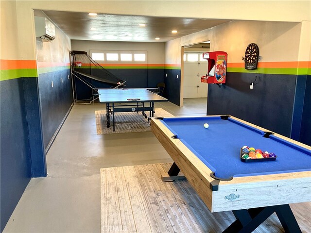 recreation room with hardwood / wood-style flooring, billiards, and a wall mounted AC