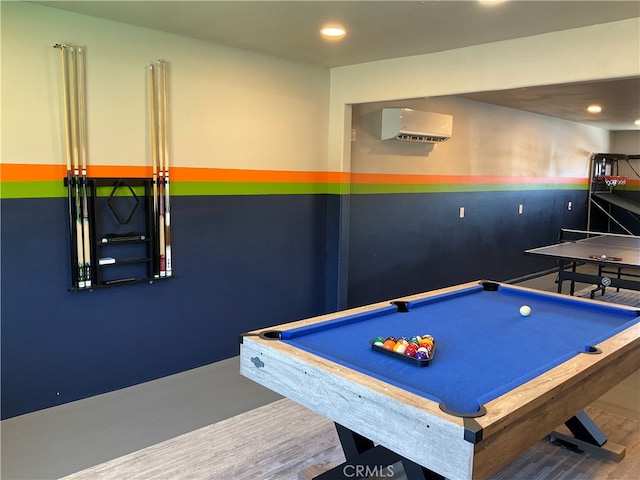 playroom featuring pool table, hardwood / wood-style floors, and a wall unit AC