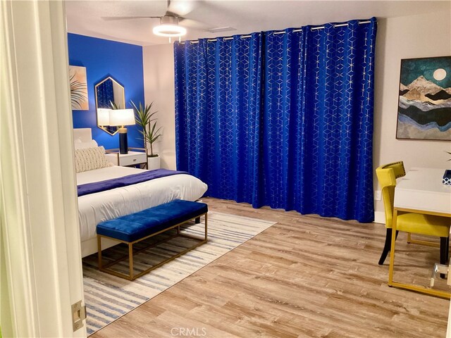 bedroom with ceiling fan and hardwood / wood-style flooring