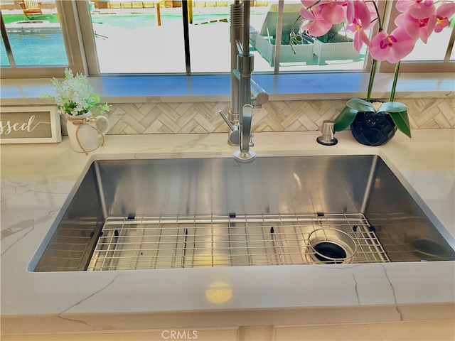 interior details featuring decorative backsplash and sink