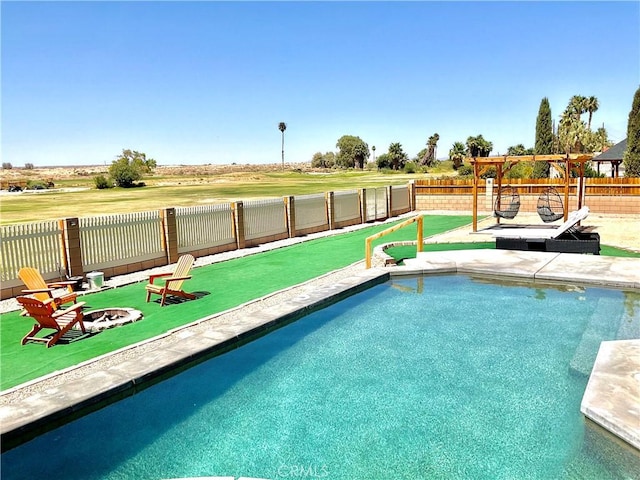 view of pool with a fenced in pool, a fire pit, and a fenced backyard