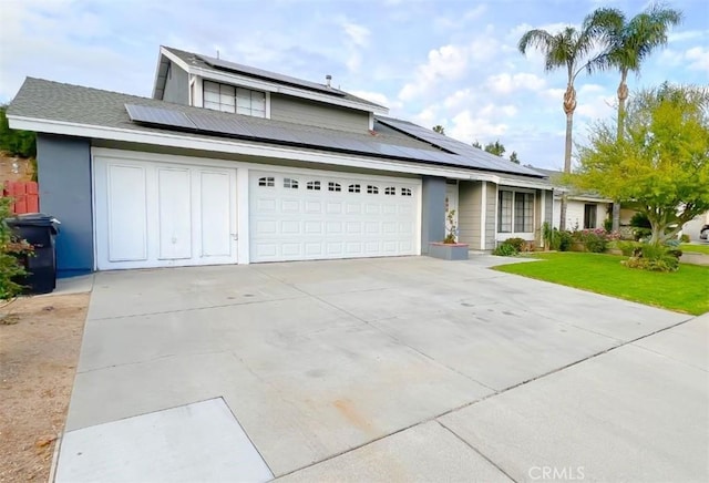 view of property with solar panels and a garage