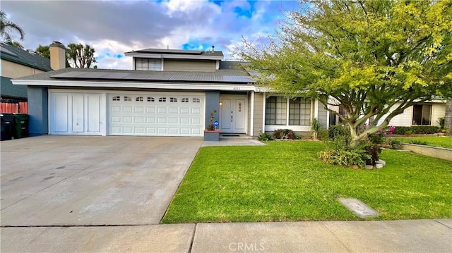 front of property featuring solar panels, a garage, and a front lawn