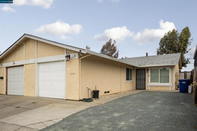 ranch-style home featuring a garage