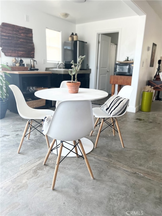 dining room with concrete flooring