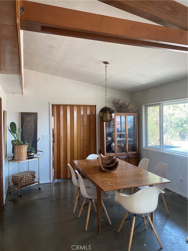 dining space with vaulted ceiling with beams