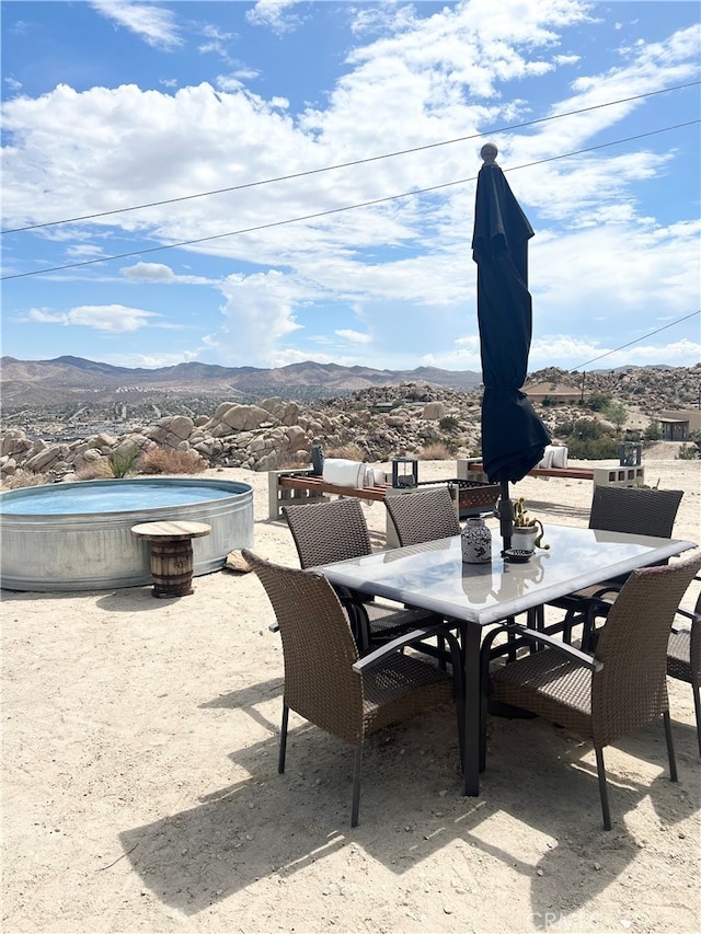 view of patio / terrace featuring a mountain view and a jacuzzi