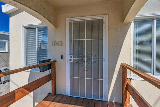 view of exterior entry with a balcony