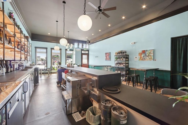 kitchen with concrete floors, ceiling fan, and decorative light fixtures