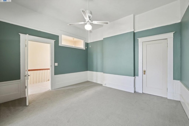 carpeted empty room with ceiling fan