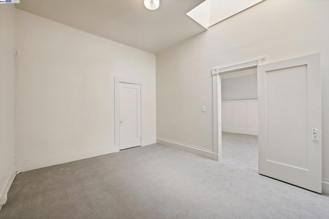 unfurnished bedroom with a closet and light carpet