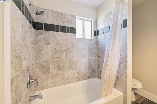 bathroom with wood-type flooring, toilet, and shower / bathtub combination with curtain