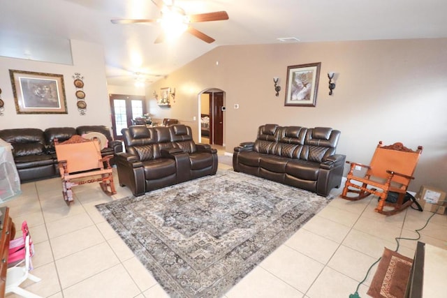 living room featuring ceiling fan, french doors, light tile patterned flooring, and lofted ceiling