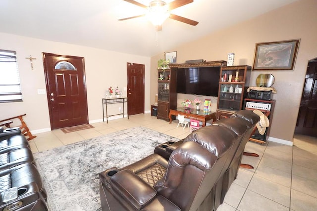 tiled living room with ceiling fan and vaulted ceiling