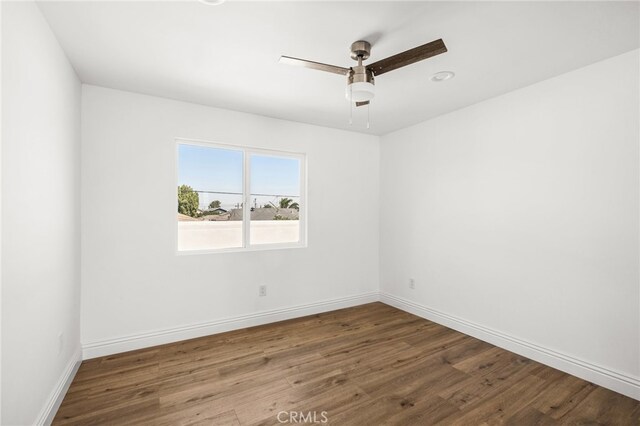 unfurnished room with dark hardwood / wood-style flooring