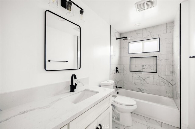 full bathroom with vanity, toilet, and tiled shower / bath