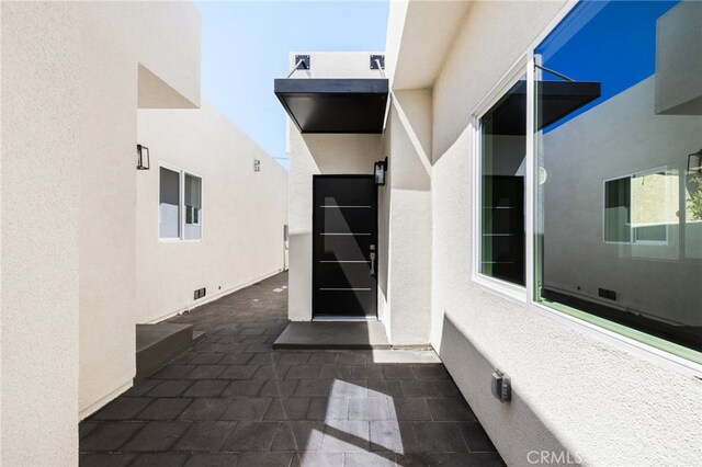 doorway to property with a patio