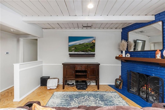 living room with beam ceiling, parquet flooring, wood ceiling, and a brick fireplace