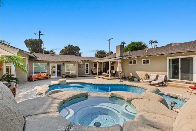 view of swimming pool with an in ground hot tub and a patio