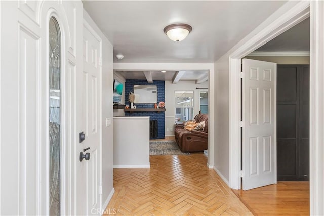 interior space featuring beam ceiling, parquet floors, and ornamental molding