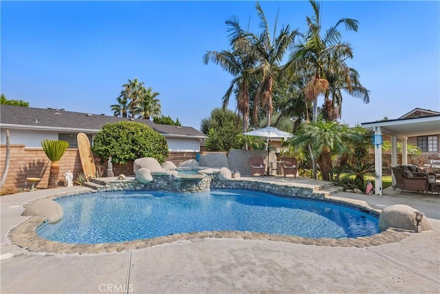 view of swimming pool featuring a patio area and an in ground hot tub