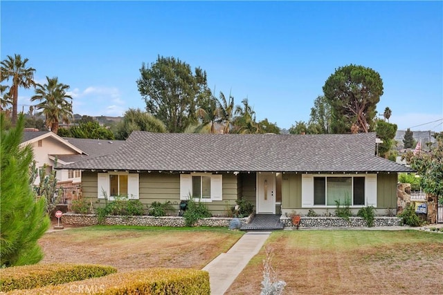 ranch-style home with a front lawn