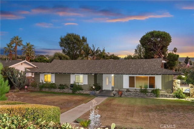 ranch-style house featuring a yard