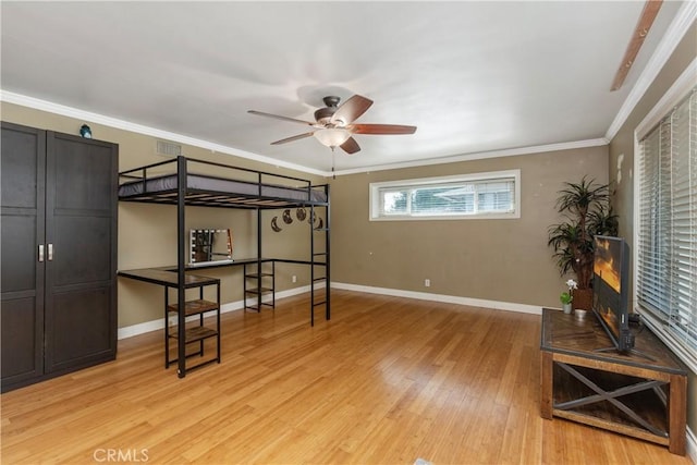 bedroom featuring crown molding and light wood-type flooring