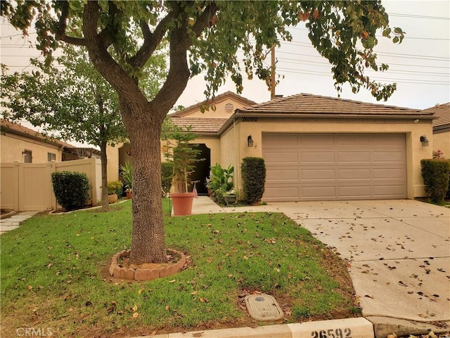 view of front of house with a garage and a front yard