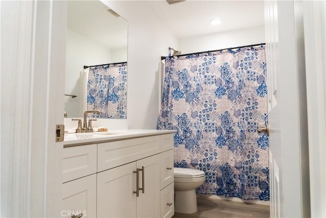 bathroom featuring hardwood / wood-style floors, vanity, and toilet