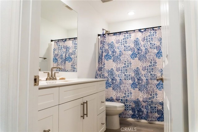 15032 Gallery Way Unit 8, Fontana, CA 92336 - bathroom featuring wood finished floors, toilet, vanity, and a shower with curtain