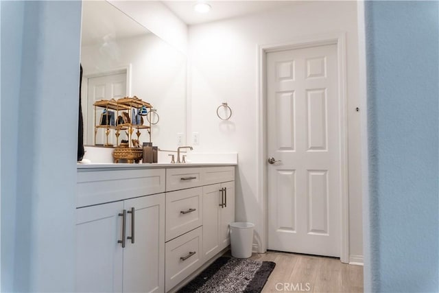 bathroom with hardwood / wood-style flooring and vanity