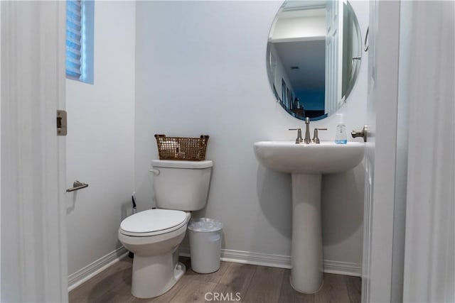 bathroom with hardwood / wood-style floors and toilet