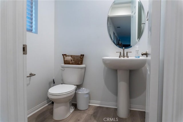 15032 Gallery Way Unit 8, Fontana, CA 92336 - half bathroom featuring toilet, baseboards, and wood finished floors