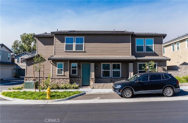 15032 Gallery Way Unit 8, Fontana, CA 92336 - view of front of home with stone siding and solar panels