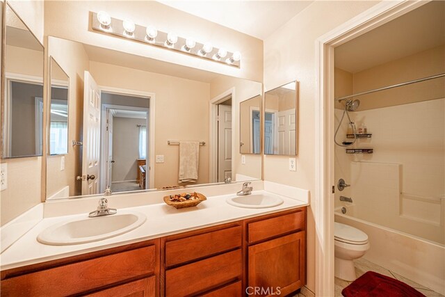 full bathroom featuring shower / tub combination, vanity, tile patterned flooring, and toilet