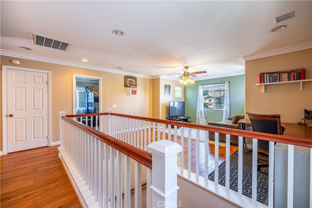 hall with wood-type flooring and crown molding