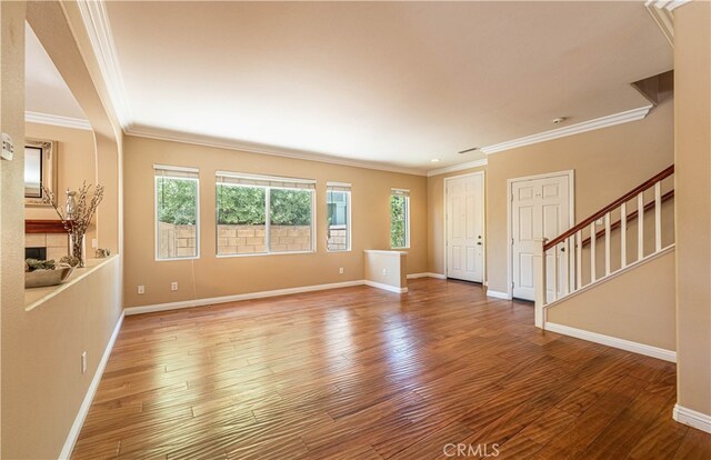 interior space with crown molding, a fireplace, and hardwood / wood-style floors