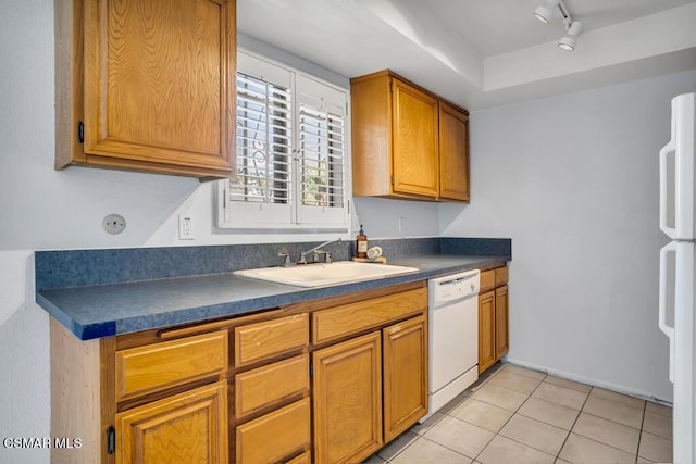 kitchen featuring light tile patterned floors, sink, rail lighting, and white appliances